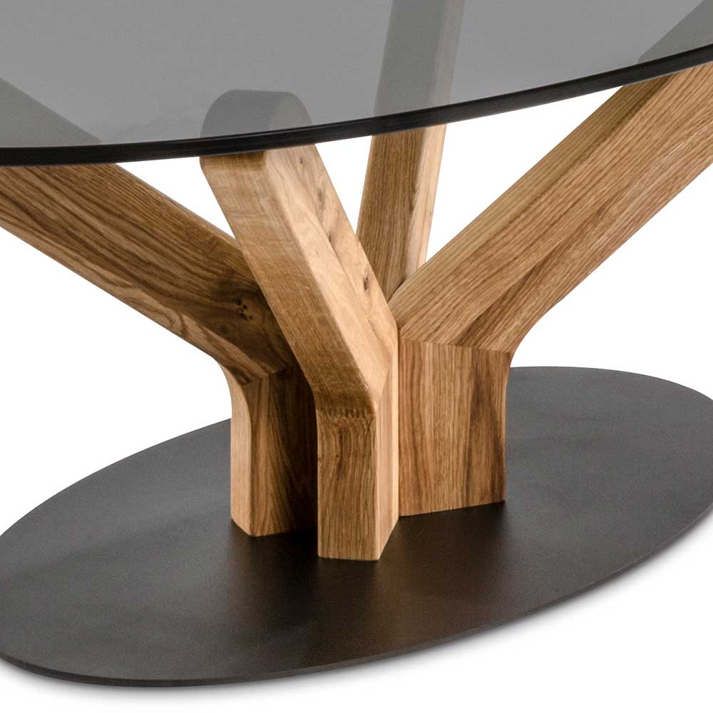 Design Couchtisch Vorenas aus Asteiche Massivholz mit ovaler Rauchglasplatte