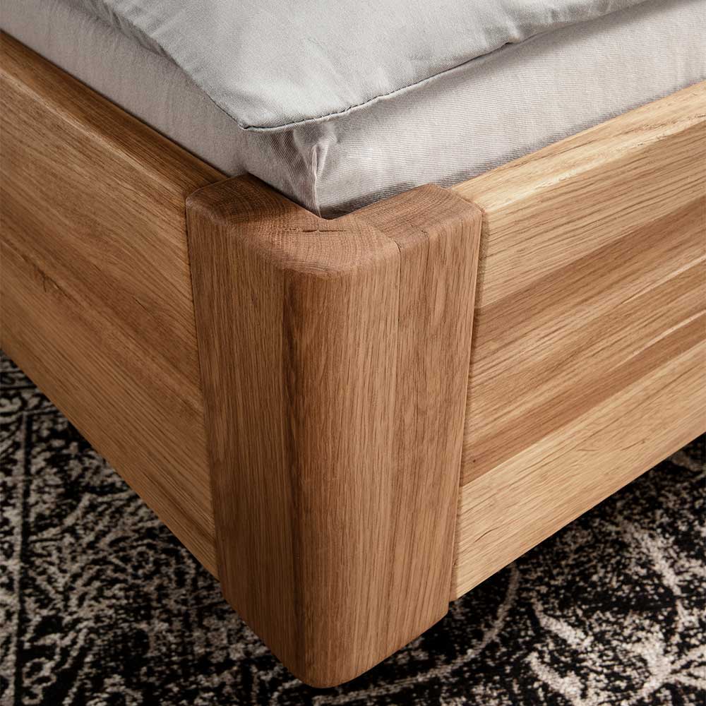 Holzkufen Bett Catania aus Wildeiche Massivholz mit Polster Kopfteil